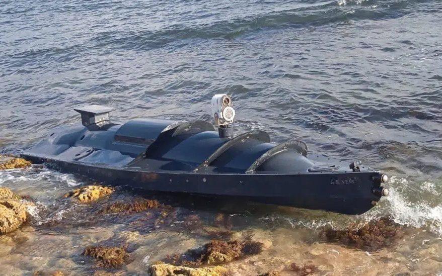 An early model of Ukrainian drone ship washed up on a rocky shoreline