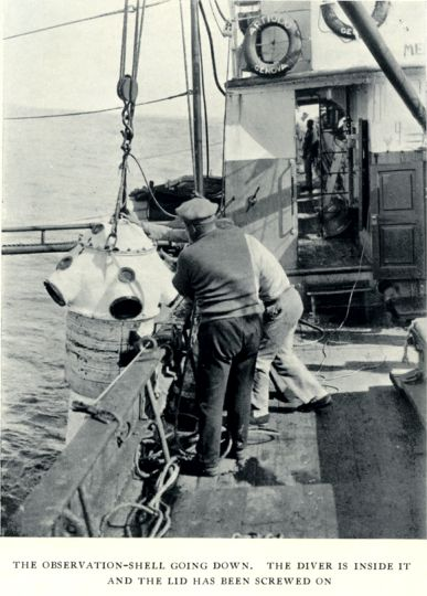 Magazine clipping of the "observation shell" - it's a cross between a diving bell and a metallic maggot - being lowered over the side of the ship