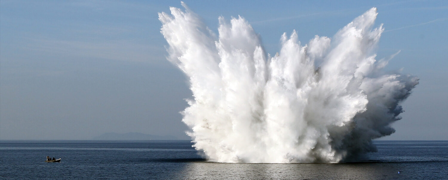 An underwater explosion hurling seawater skyward