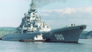 Russian cruiser Admiral Nakhimov being attended to by a tug